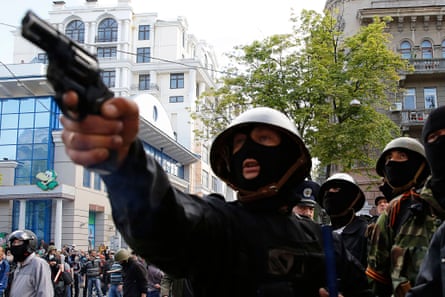 A pro-Russia activist aims a pistol at supporters of the Kiev government during clashes in the streets of Odessa, 2 May 2014.