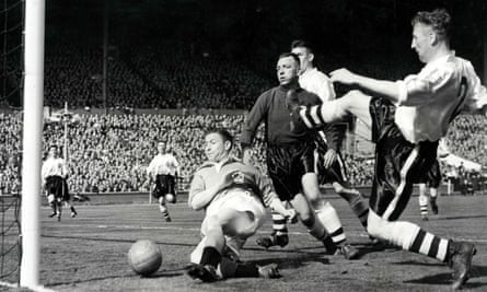 Blackpool's Stan Mortensen falls to the ground as he scores his side's second goal on his way to completing a hat-trick in the 1953 FA Cup final.