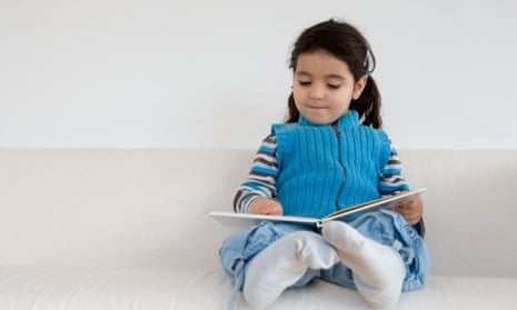 Little girl pretending to read a book