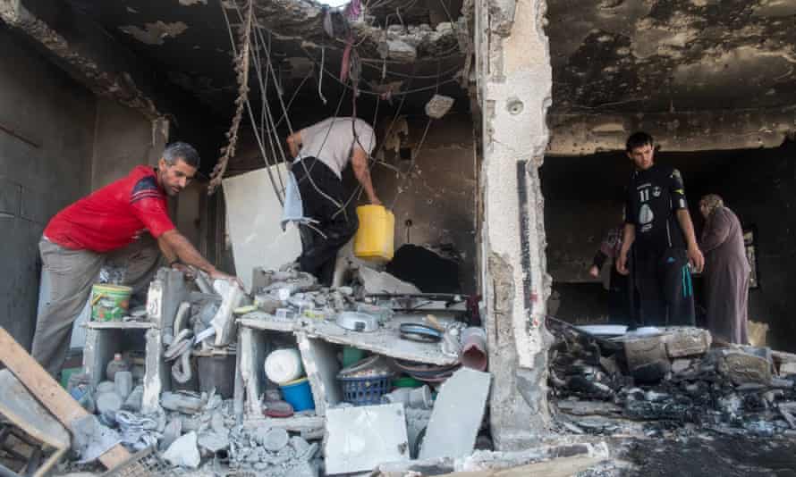 Palestinians recover possessions from the ruins of their home during a truce in the 2014 Gaza war.