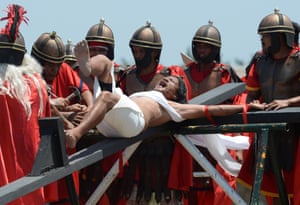 Cutud, Philippines Penitent Ruben Enage cries out as he is nailed to a cross in the Philippines
