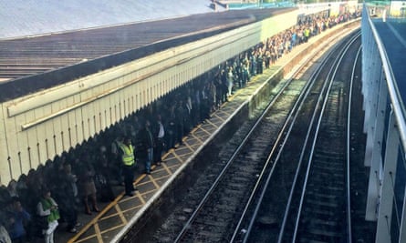 Commuters waiting on a platform at Clapham Junction.