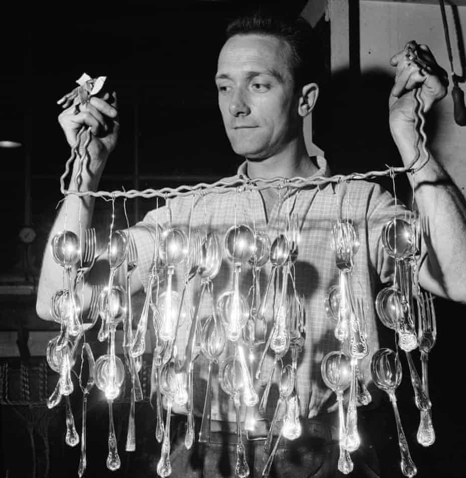 A worker hanging out newly silver-plated forks and spoons to dry at a Sheffield steel cutlery factory, 1959.