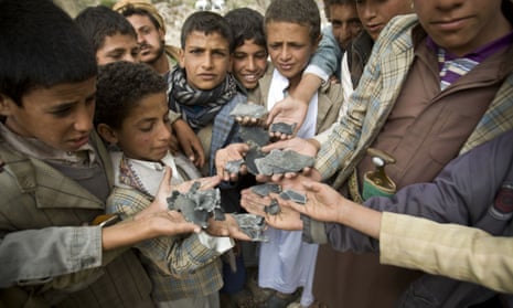 In this April 4, 2015, file photo, Yemeni boys display shrapnel they collected from the rubble of houses destroyed by Saudi-led airstrikes in a village near Sanaa, Yemen.
