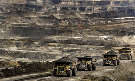 Mining lorries carry loads of tar sands in Alberta, Canada. One climate scientist warned that it would be “game over” for efforts to stop global warming if Canada’s tar sands were fully exploited.