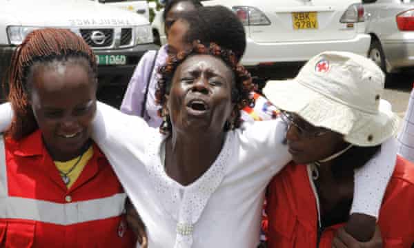 Red Cross staff console a woman in Nairobi after she viewed the body of a relative killed in Thursday's attack.
