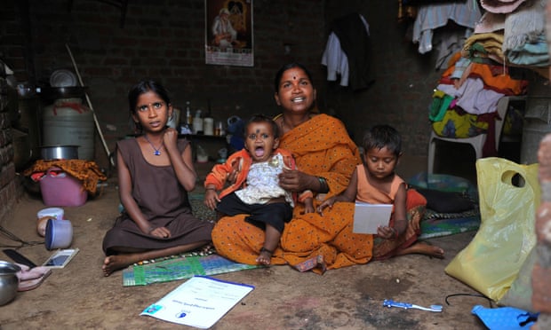 Kommani Lalitha poses with her daughters and her microfinance ‘loan recovery book’ at her residence in the Ranga Reddy District, in the outskirts of Hyderabad, India. Microfinance, one of the most widely touted tools for alleviating poverty, has come under fire recently.