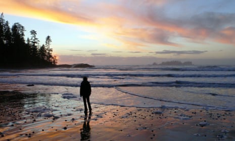 A woman walks at sunset on western Vancouver Island's Halfmoon Bay beach, near Ucluelet, British Columbia. Trace amounts of radiation from the Fukushima disaster have been discovered in the area.