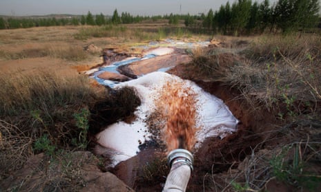 A pipe discharging factory waste water from a coal-to-liquid project into a stream in the hills in Inner Mongolia. A protest among villagers in the region has left one dead and multiple arrests.