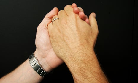 Two men's hands, one with a wristwatch on the arm