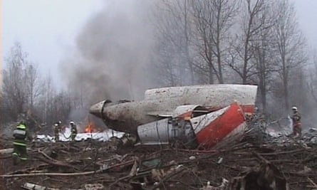 A firefighter walking near some of the wreckage at the crash site.