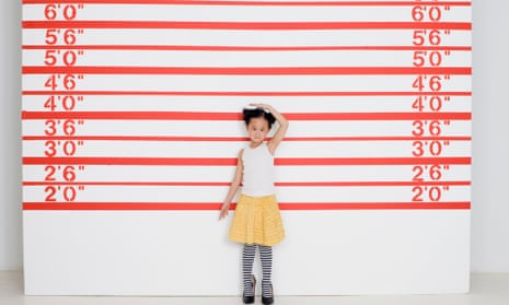 A young girl measures herself in front of growth chart. Natural selection and good environmental conditions may help explain why the Dutch are so tall.