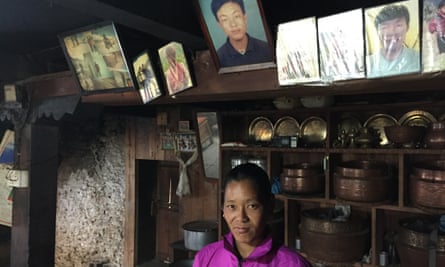 Kandi Sherpa, widow of Pasang Karma Sherpa, who was killed the 2014 avalanche on Everest, beneath portraits of her husband in her home in Nepal.