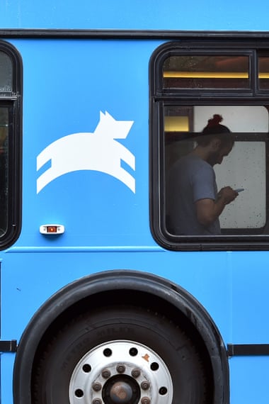 A Leap Transit employee checks his phone while riding on one of the company's new luxury buses in San Francisco