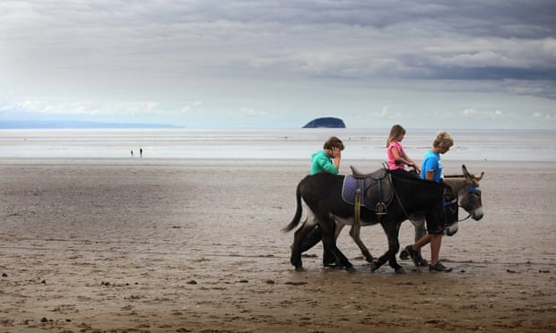 Holidaymakers take a donkey ride on the near deserted beach on August 30, 2011 in Weston-Super-Mare, England. According to weather experts the UK's summer has been one of the coldest for many years.