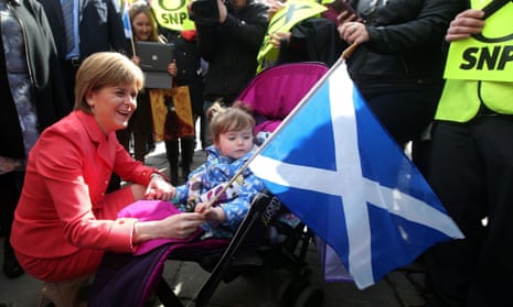 Nicola Sturgeon holds a Scottish flag while campaigning in Aberdeen.