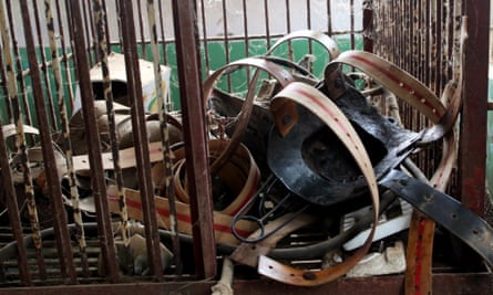 The metal jackets taken off from bears are put in a cage at a bear bile farm in Weihai city, east Chinas Shandong province, 19 April 2010. The illegal metal jacket had just been taken off by the farmer in Weihai in eastern Chinese province of Shandong, and flung into a corner.