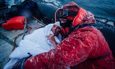 In this Feb. 19, 2015 photo, provided by 5 Swims Expedition, Lewis Pugh, of the United Kingdom, is wrapped in blankets to help warm his body in the Ross Sea in Antarctica. An extreme swimmer from Britain, Pugh completed the last of four swims in the ocean near Antarctica this month, including two that were further south than anybody had ever swum before.