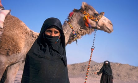 Bedouin women with camels on the African Sahara.