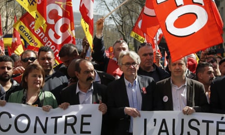 French CGT trade union leader Philippe Martinez, centre left, flanked by French union FO, Force Ouvriere, secretary general Jean-Claude Mailly, right, hold a banner reading "against austerity" as part of a demonstration march in Paris.