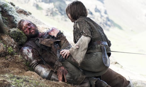 An injured Sandor Clegane, better known as The Hound and Arya Stark in a scene from season four of Game of Thrones.