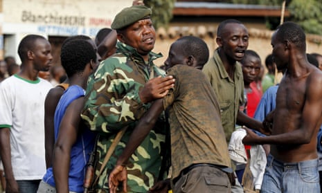 A military officer tangles with protesters in Burundi's capital, Bujumbura.