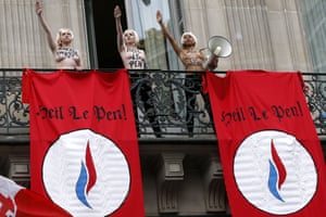 <strong>Paris, France </strong>Topless Femen activists perform the Nazi salute near flags reading “Heil Le Pen” as they demonstrate on a balcony against France’s far-right Front National (FN) political party during an FN rally in honour Joan of Arc