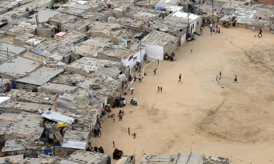 Residents walk in the shanty town of Boa Vista in the Angolan capital Luanda. Press freedom in the country is limited.