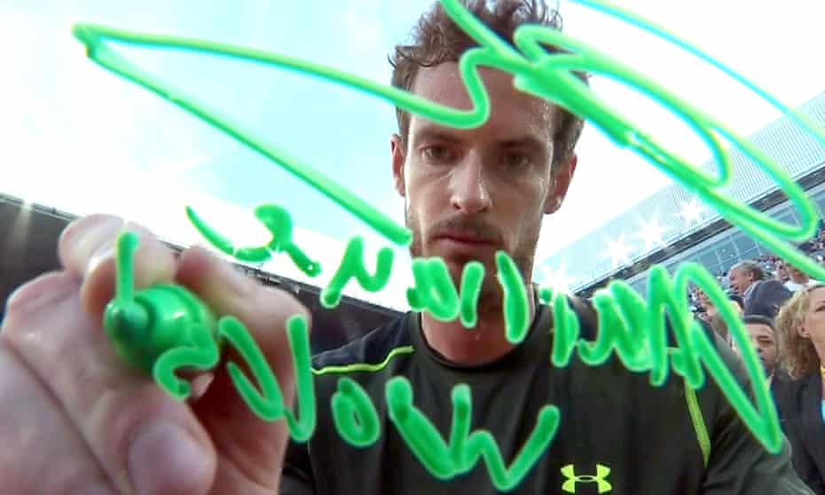 Andy Murray writes "marriage works"  on a camera lens after beating Rafael Nadal in the final of the Madrid Open.