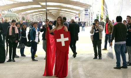 A model poses next to the Swiss pavilion on the opening day of Expo 2015.