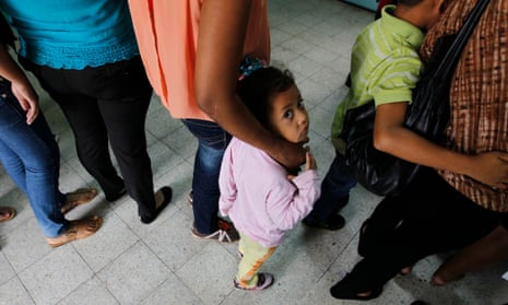 Women and their children wait in line to register at the Honduran Center for Returned Migrants after being deported from Mexico, in San Pedro Sula, northern Honduras June 20, 2014. Thousands of young people are hoping to reach the U.S. from their impoverished and violent homes in Central America. In the eight months ended June 15, the U.S. has detained about 52,000 children at the Mexican border, double the figure the year earlier. There is no telling how many have gotten through. Picture taken June 20, 2014. To match Feature USA-IMMIGRATION/MEXICO     REUTERS/Jorge Cabrera (HONDURAS - Tags: SOCIETY POLITICS IMMIGRATION TPX IMAGES OF THE DAY):rel:d:bm:GF2EA6O18HW01