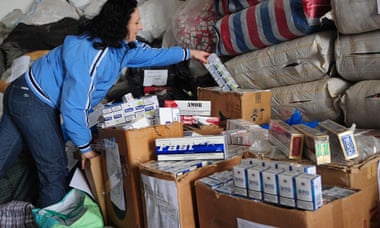 A Romanian customs officer shows seized smuggled cigarettes.