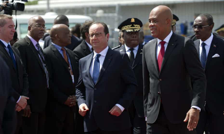 French president François Hollande is welcomed by the President of Haiti, Michel Martelly upon his arrival in Haiti.