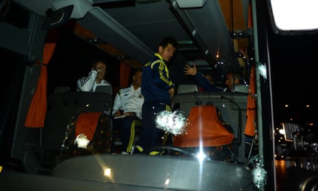 Fenerbahce's Emre Belozoglu and head coach Ismail Kartal, right, standing inside their bus after the attack  in northern Turkey last month.