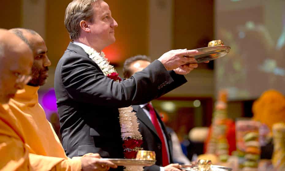 David Cameron takes part in a ceremony at a Hindu temple