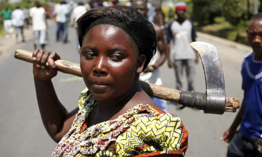 A female protester holds an axe during a protest against Nkurunziza.