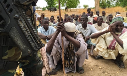 Men in the Cameroon village of Bia, which was attacked by Boko Haram