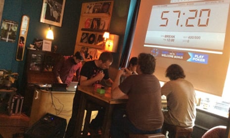 Four players (and DJ) at a Netrunner tournament in London's Loading Bar.