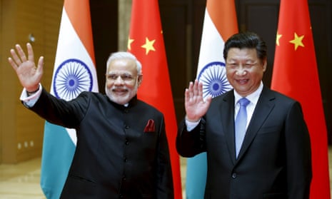 Indian Prime Minister Narendra Modi (L) and Chinese President Xi Jinping wave to journalists before they hold a meeting in Xian, Shaanxi province, China, May 14, 2015.
