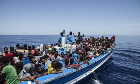 Migrants on a wooden boat in the Mediterranean