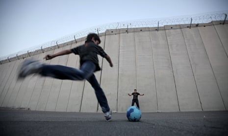 TOPSHOTS Palestinian children play footb