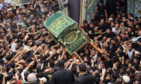 Shia pilgrims carry a symbolic coffin at the holy shrine of Imam Moussa al-Kazim shrine to commemorate his death in the Shia district of Kazimiyah, Baghdad, Iraq, 14 May 2015.