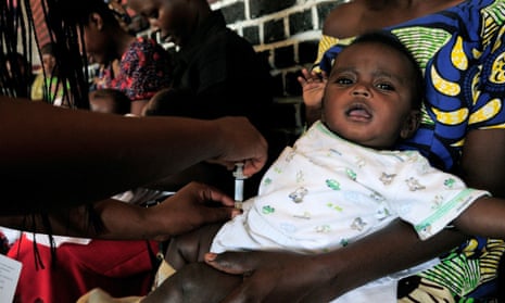 An infant receives a pneumococcal vaccine at the Nyamata health centre in Rwanda's Bugesera district. The country's universal health insurance programme has been a resounding success.