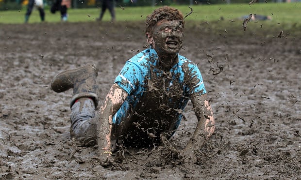 Tom Wilder, 17 from Kent, dives in the mud at the Glastonbury Festival on 23 June 2011