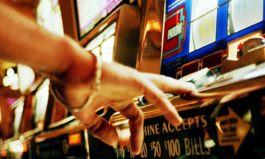 A hand operating slot machine  in casino, Las Vegas, Nevada.
