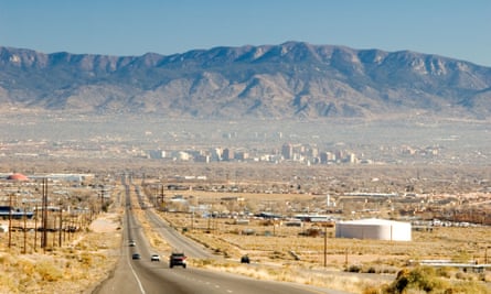The historic Route 66 highway leading into Albuquerque, with the Sandia Mountains beyond.