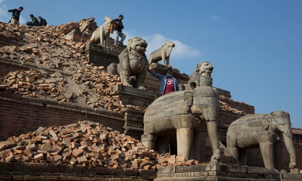 Nepalese visitors walk on ruins near the Nyatapola temple in Bhaktapur. The temple itself survived the earthquake.