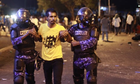 Police detain an opposition supporter during a protest on Friday demanding resignation of president Yameen Abdul Gayoom.