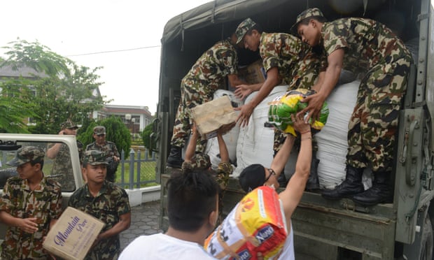 Nepalese soldiers load relief aid from residents of Sikkim, India, at Kakarvitta on Saturday.
