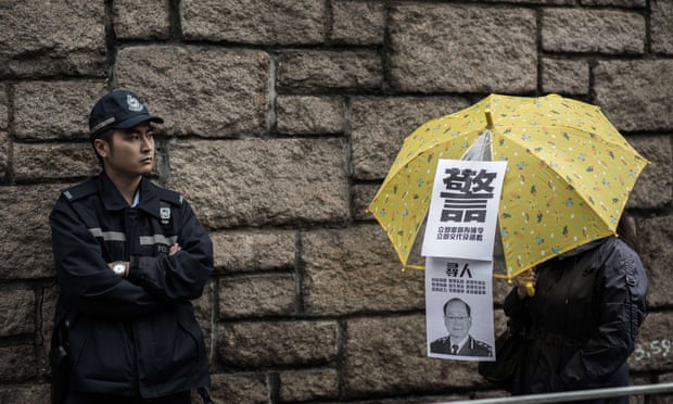 A Hong Kong policeman looks at a demonstrator holding an umbrella while taking part in a democracy march in 2014. Concerns over press freedom in the former British colony has led to the start up of a new independent newspaper.